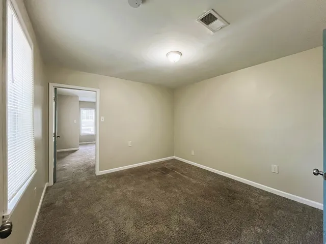 an empty room with a empty space and windows