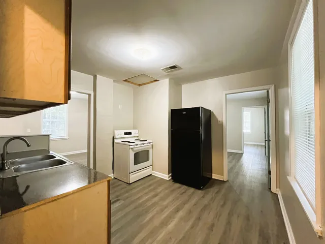 a kitchen with a refrigerator and a stove