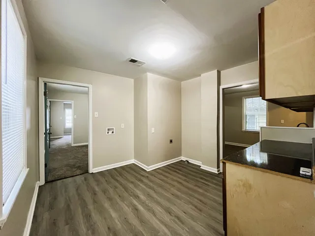 a view of a room & wooden floor