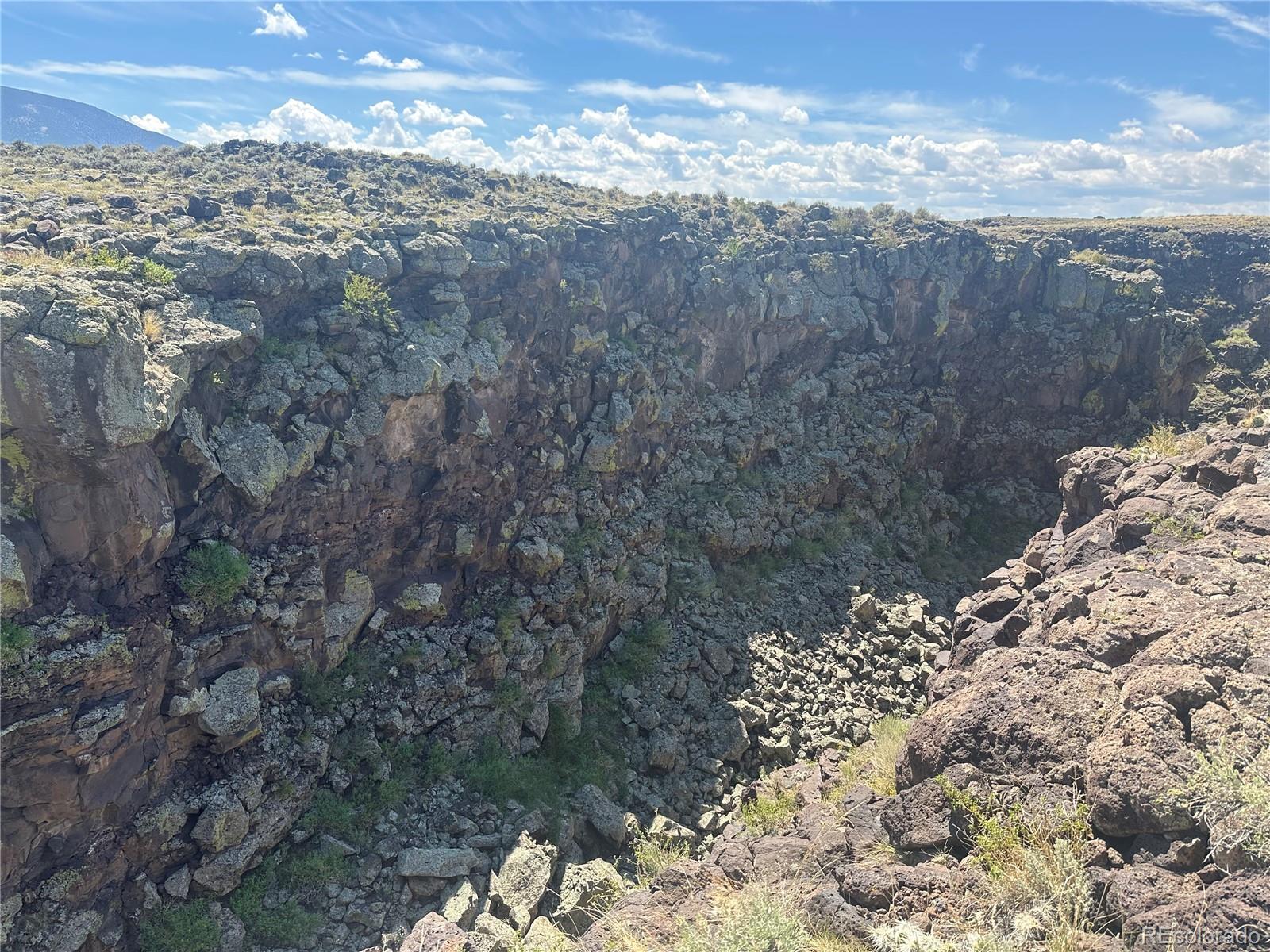 3946 County Rd B San Luis, CO 81152 - Photo 25 of 49 a view of a yard of the house and a mountain