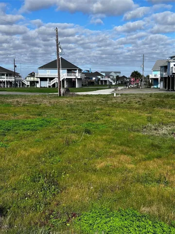 a view of a big building with a big yard and trees