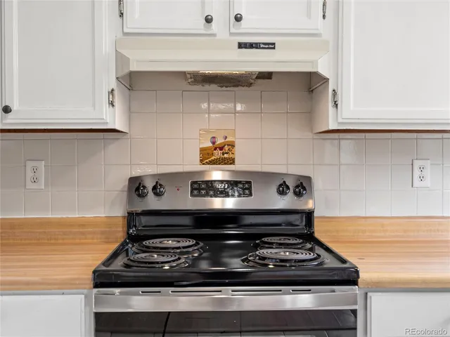 a stove top oven sitting inside of a kitchen