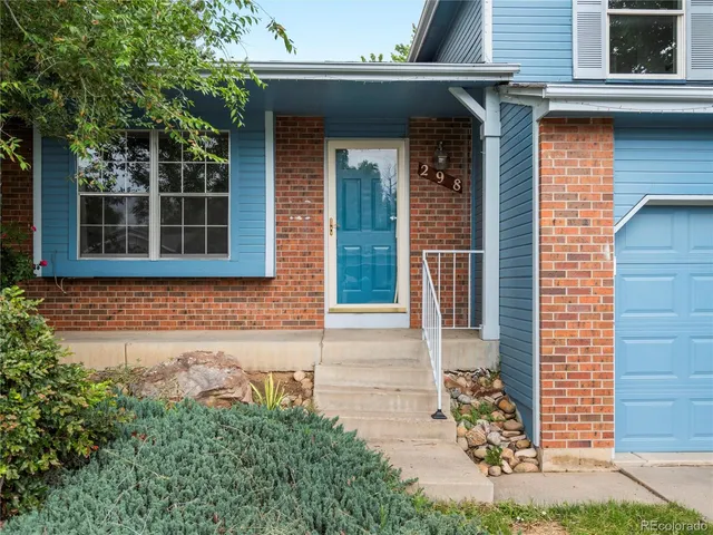 front view of a brick house with a small yard