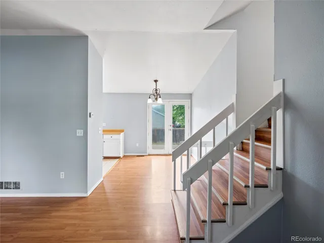 a view of entryway and hall with wooden floor