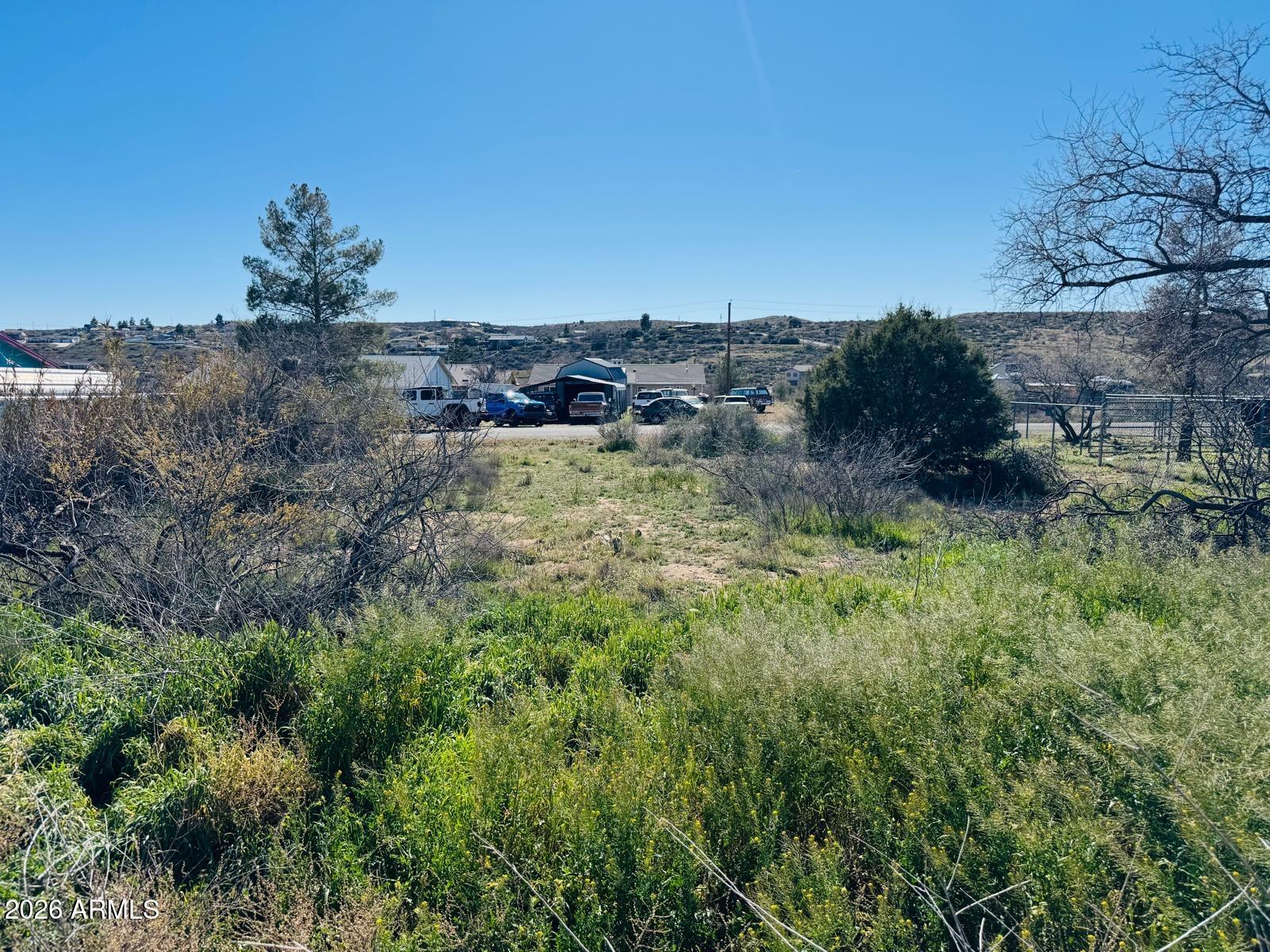 20126 East Antelope Road, Unit 1068 Mayer, AZ 86333 - Photo 4 of 6 a view of a yard with a house in the background