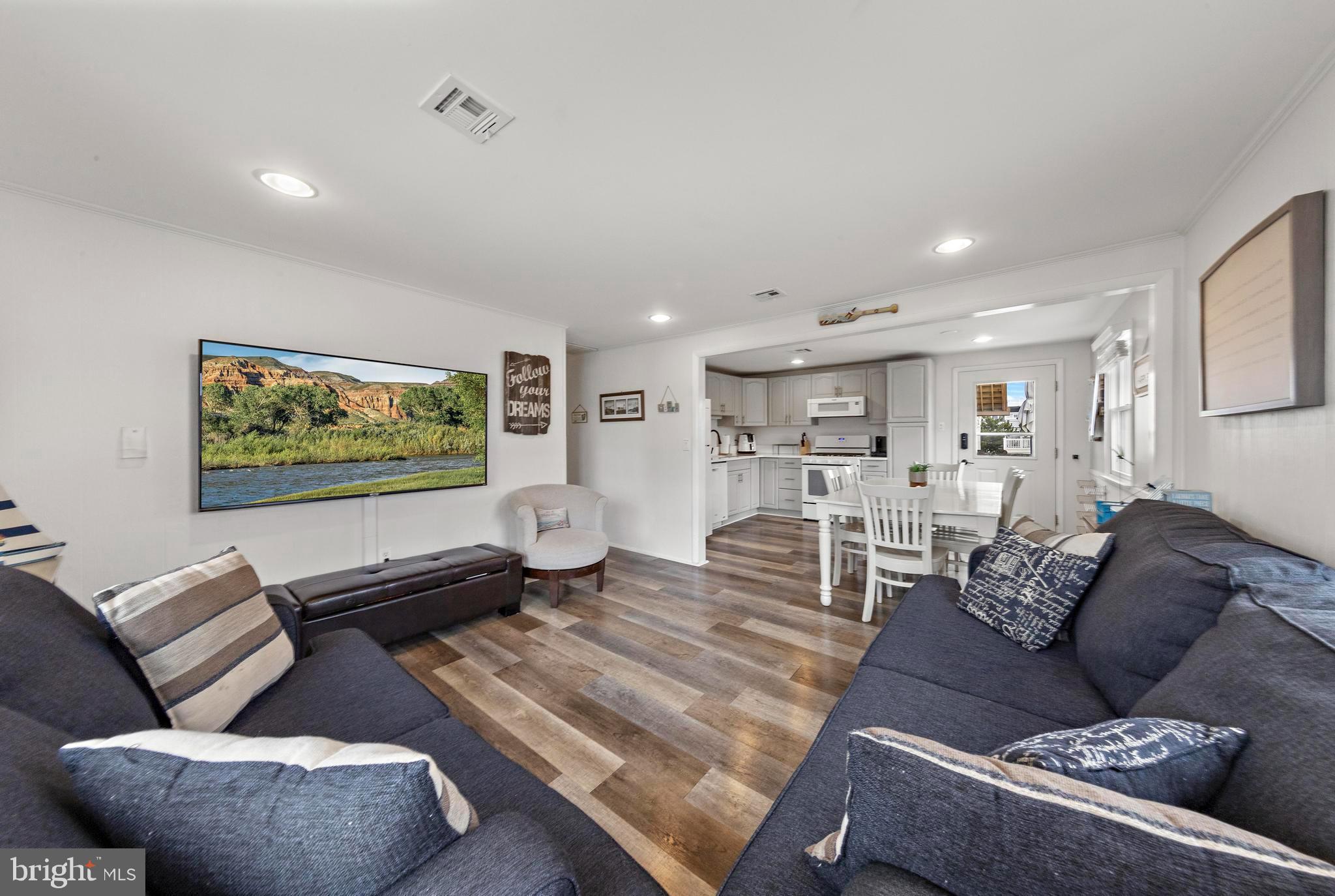13 Joan Road, Unit 2 Long Beach Township, NJ 08008 - Photo 12 of 64 a living room with furniture and a flat screen tv