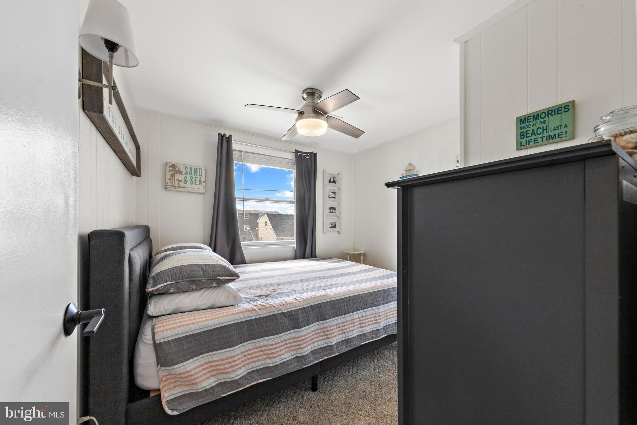 13 Joan Road, Unit 2 Long Beach Township, NJ 08008 - Photo 22 of 64 a bedroom with a bed and a chandelier