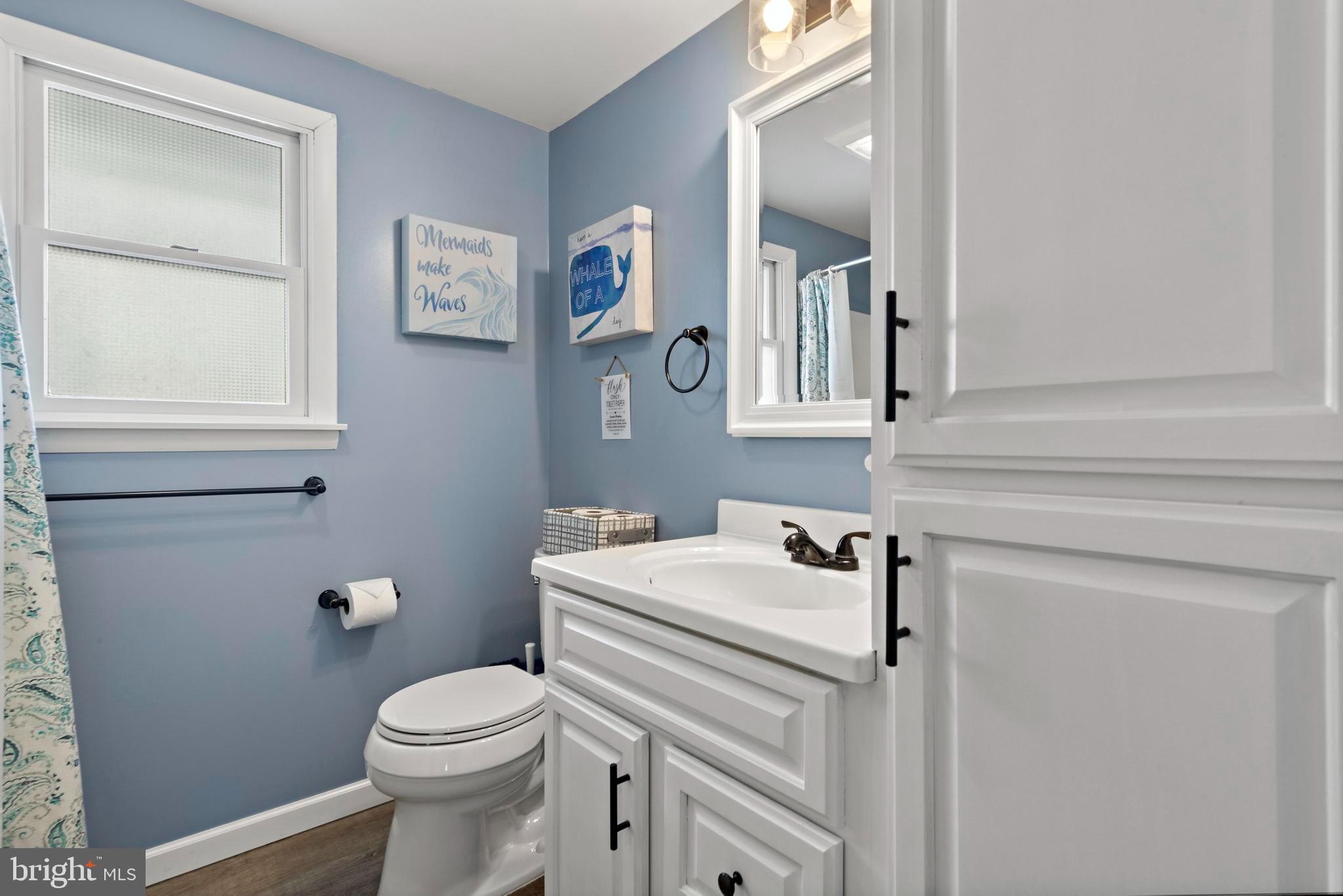13 Joan Road, Unit 2 Long Beach Township, NJ 08008 - Photo 24 of 64 a bathroom with a sink a toilet and mirror