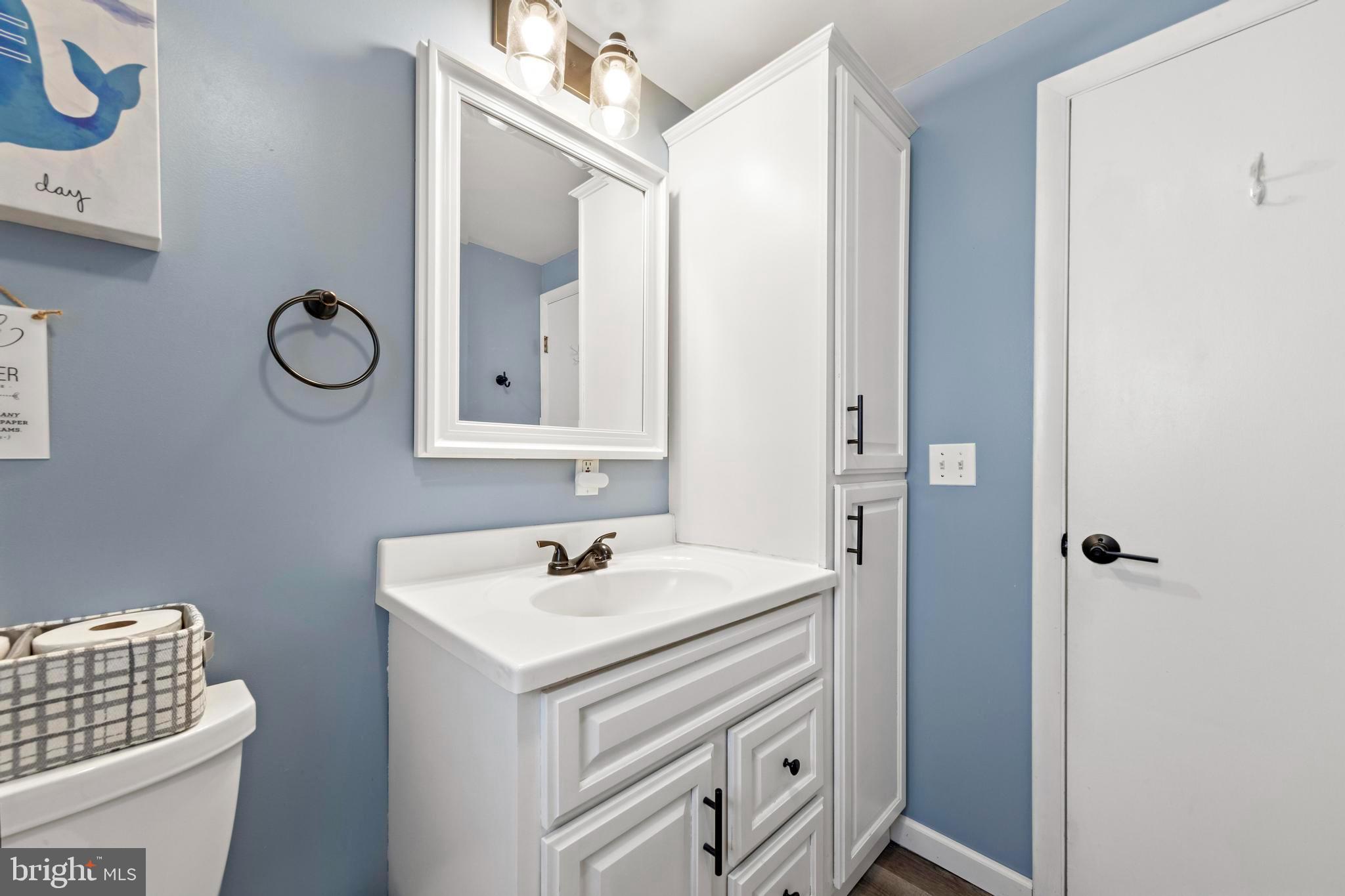 13 Joan Road, Unit 2 Long Beach Township, NJ 08008 - Photo 25 of 64 a bathroom with a sink and a mirror