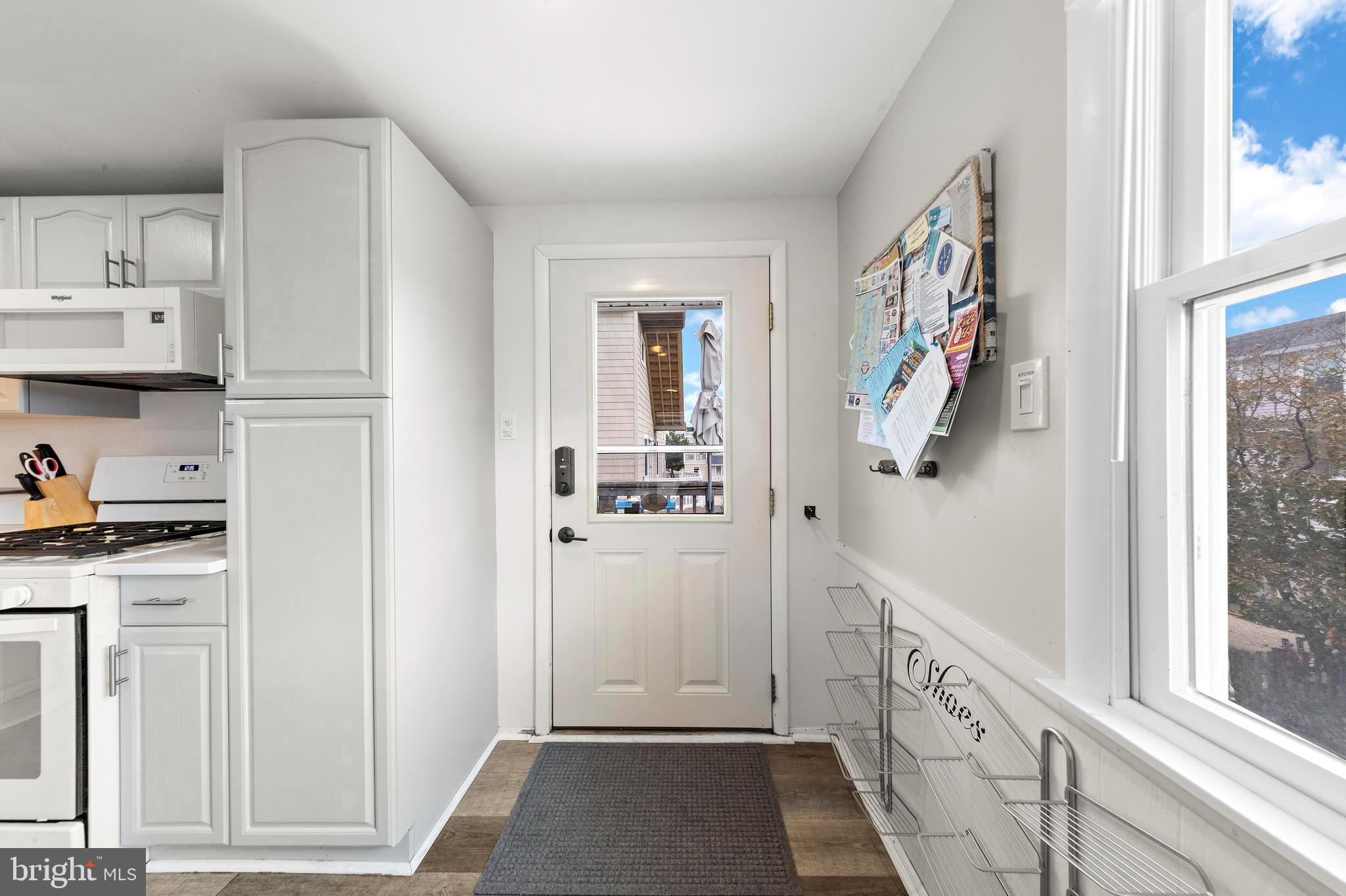 13 Joan Road, Unit 2 Long Beach Township, NJ 08008 - Photo 46 of 64 a view of a kitchen with white cabinets and wooden floor