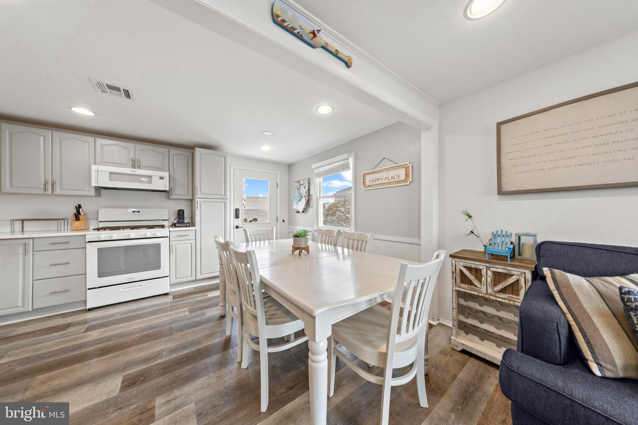 13 Joan Road, Unit 2 Long Beach Township, NJ 08008 - Photo 7 of 64 a view of a dining room with furniture and wooden floor