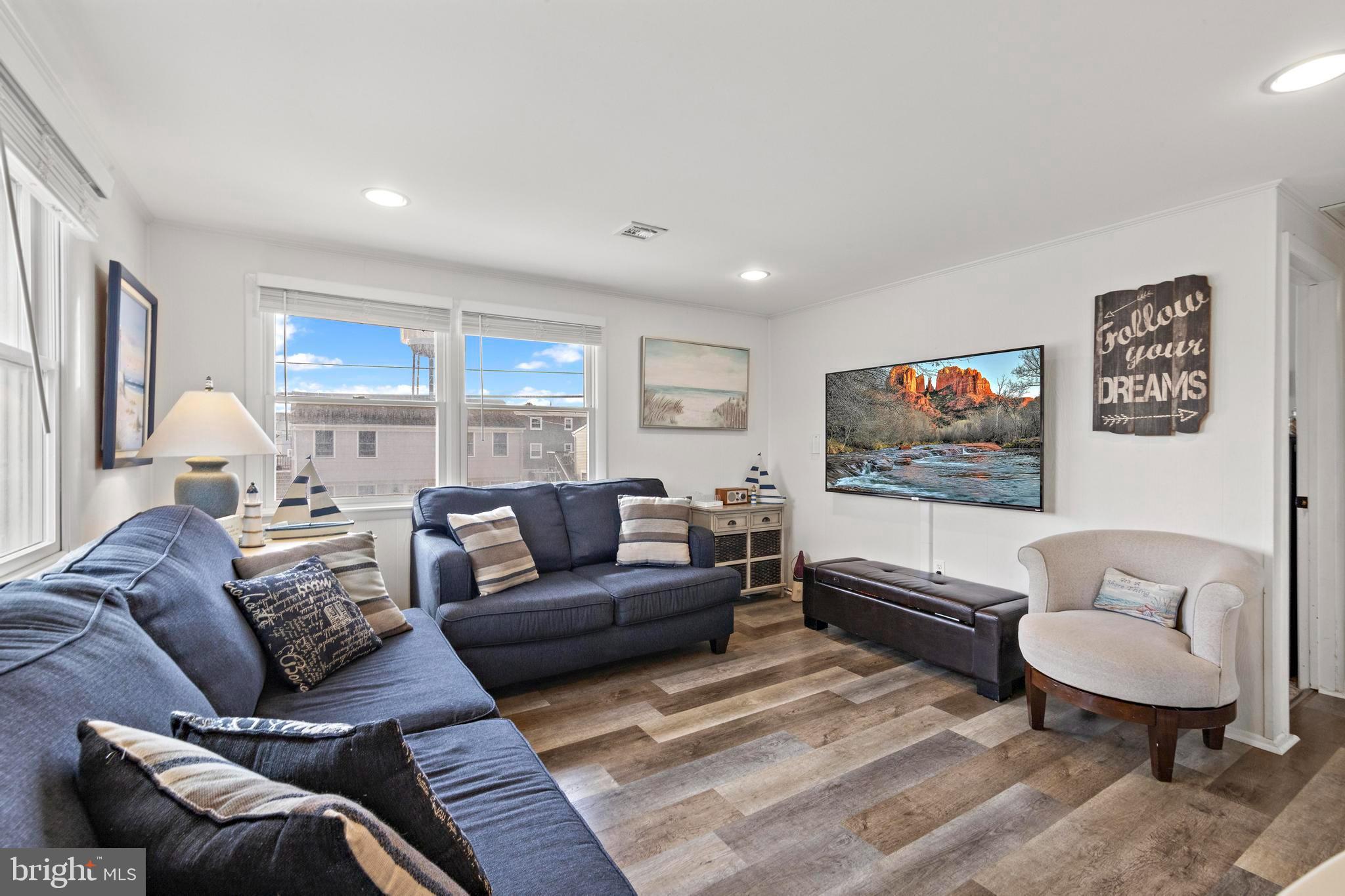 13 Joan Road, Unit 2 Long Beach Township, NJ 08008 - Photo 10 of 64 a living room with furniture and a flat screen tv