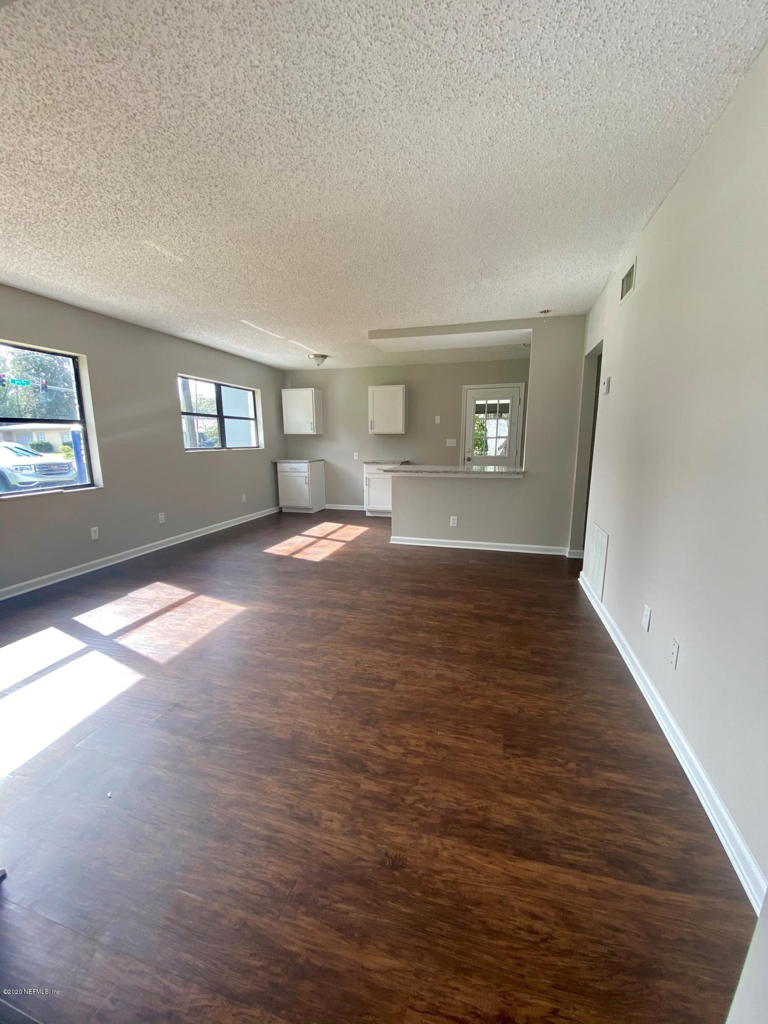 4903 Spring Glen Road Jacksonville, FL 32207 - Photo 4 of 11 a view of empty room with window and wooden floor
