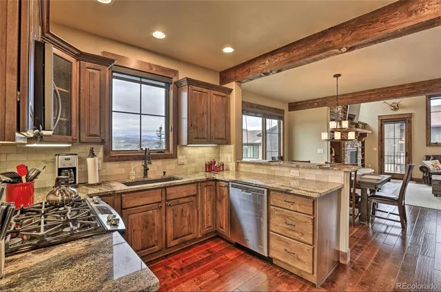 a kitchen with lots of counter top space and wooden floor