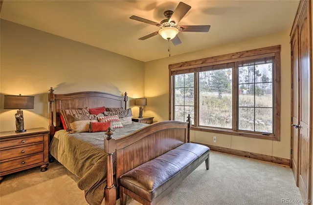 a bedroom with a bed couch and window