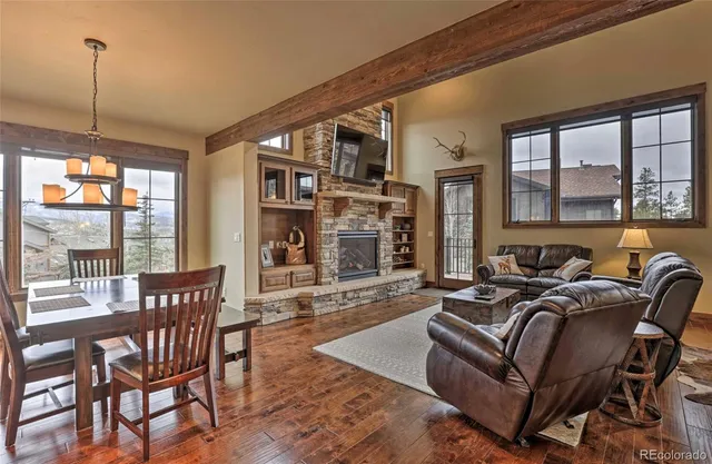 a living room with furniture a flat screen tv and a large window