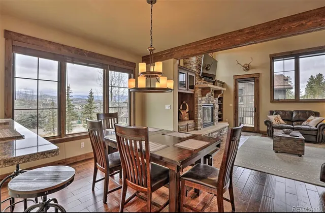 a view of a dining room with furniture large windows and wooden floor