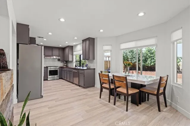 a view of a dining room with furniture and a kitchen