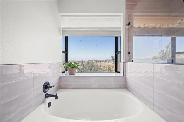 a bedroom with a large bed and a large window