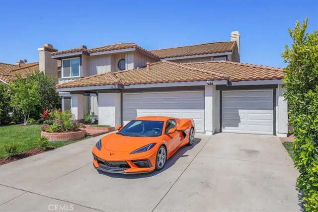 front view of a house with a yellow lightning and a yard