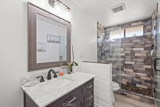 a bathroom with a toilet a sink and a mirror