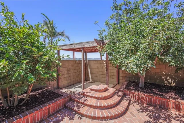 a front view of a house with a garden and plants