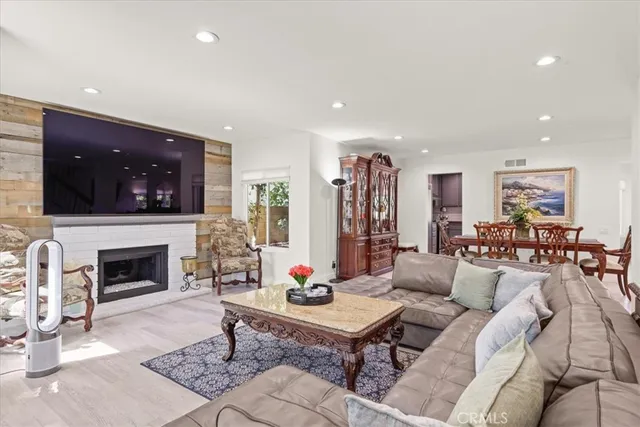 a living room with fireplace furniture and a flat screen tv