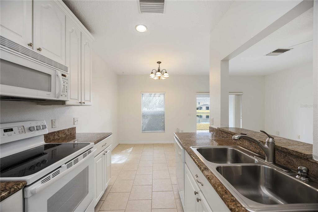 14980 Skip Jack Loop Lakewood Ranch, FL 34202 - Photo 11 of 39 a kitchen that has a sink and a stove