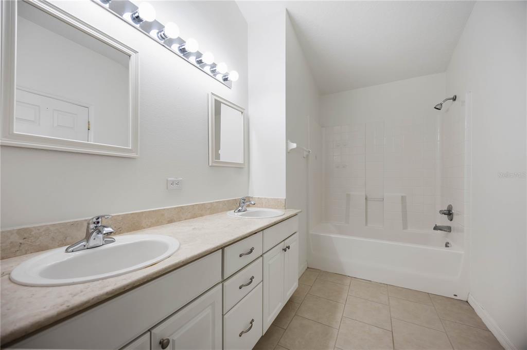 14980 Skip Jack Loop Lakewood Ranch, FL 34202 - Photo 21 of 39 a bathroom with a sink double vanity granite tub and a mirror
