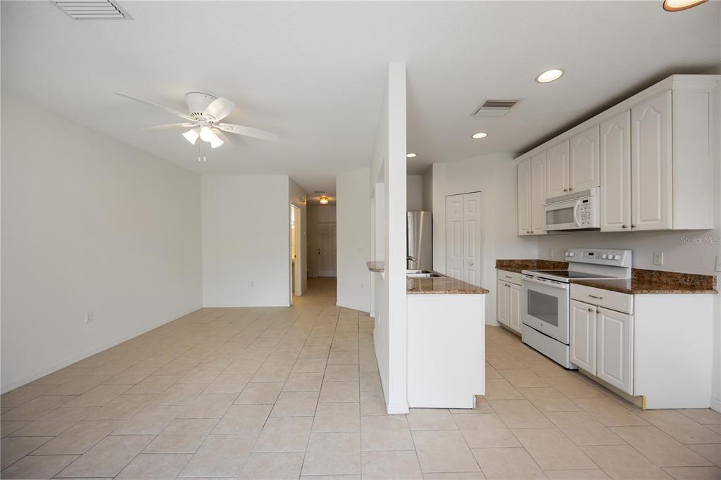 14980 Skip Jack Loop Lakewood Ranch, FL 34202 - Photo 8 of 39 a large kitchen with cabinets and stainless steel appliances