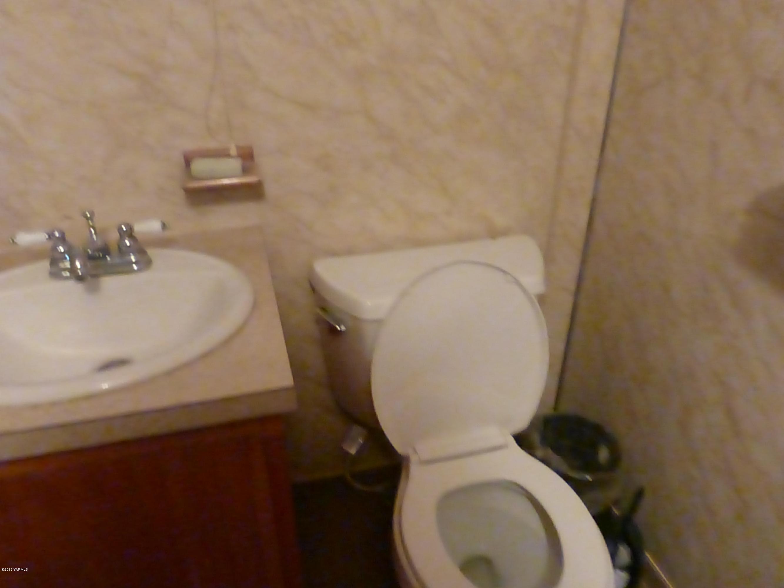 461 Barker Road Granger, WA 98932 - Photo 17 of 37 a white toilet sitting next to a white sink