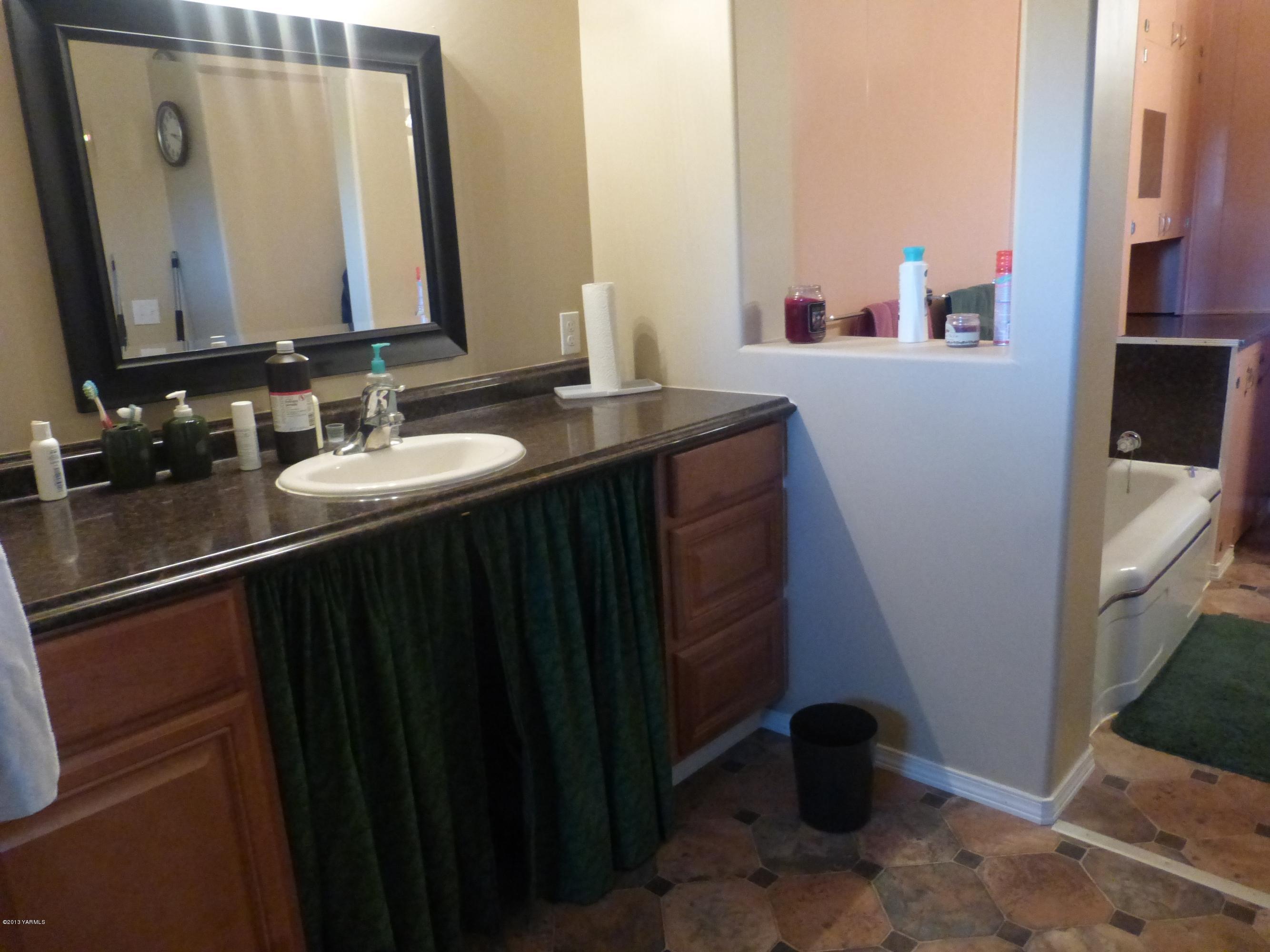 461 Barker Road Granger, WA 98932 - Photo 25 of 37 a bathroom with a sink and a mirror