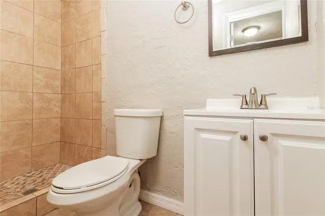 a white toilet sitting next to a bathroom sink
