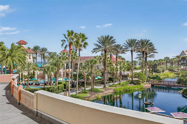 a bedroom with a large bed and a flat tv screen on dresser