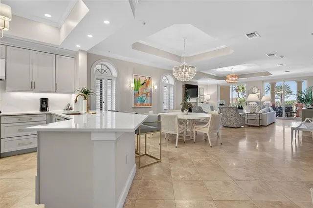 a living room with furniture a chandelier and a window