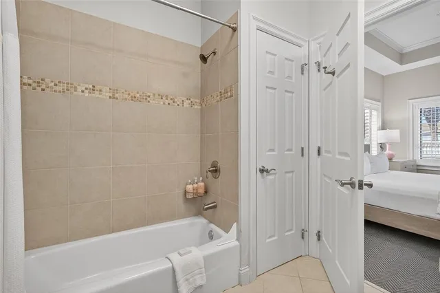 a living room with lots of furniture and a kitchen view