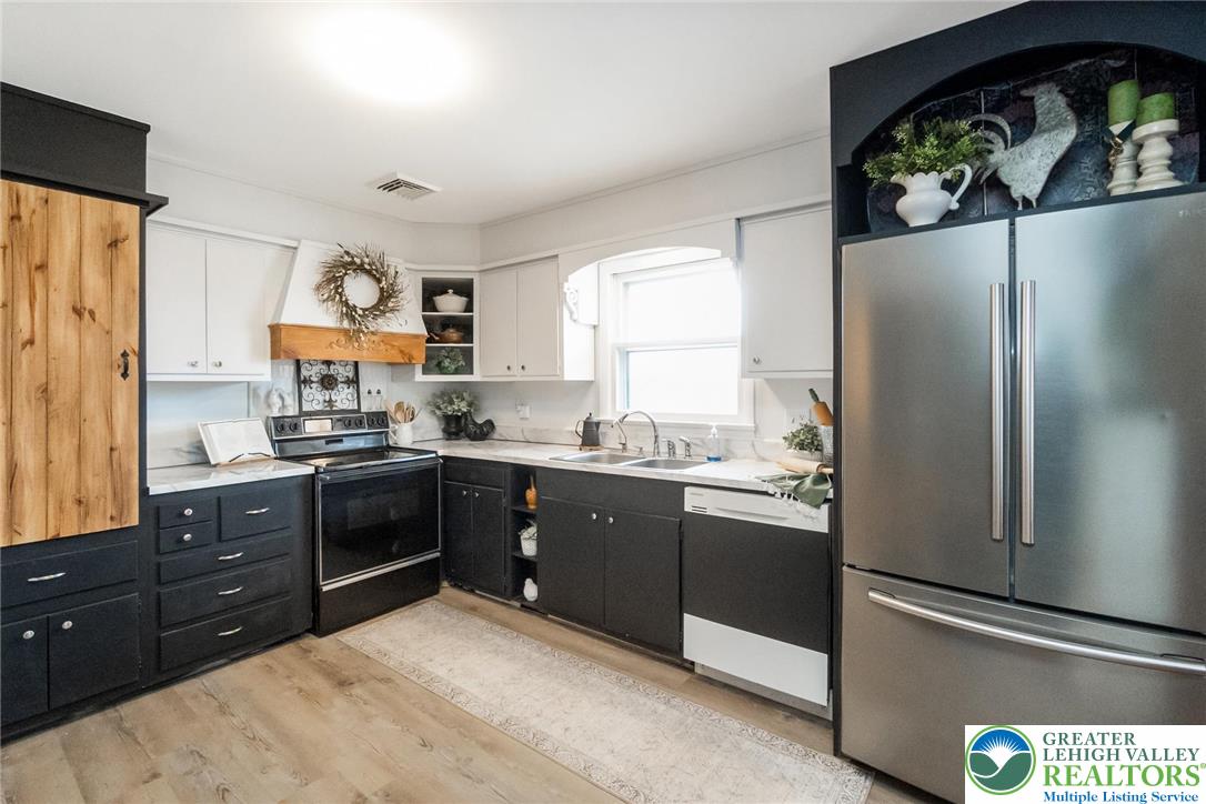 3218 Highland Road Orefield, PA 18069 - Photo 15 of 53 a kitchen with stainless steel appliances granite countertop a refrigerator and a sink