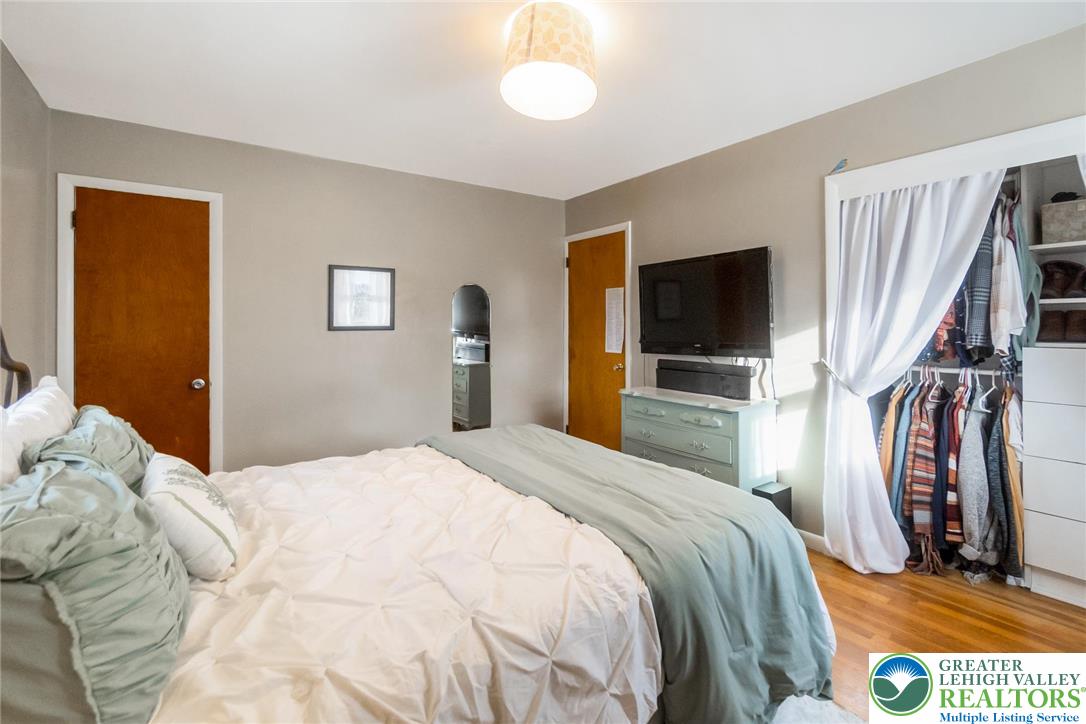 3218 Highland Road Orefield, PA 18069 - Photo 20 of 53 a bedroom with a bed and a flat tv screen on the dresser