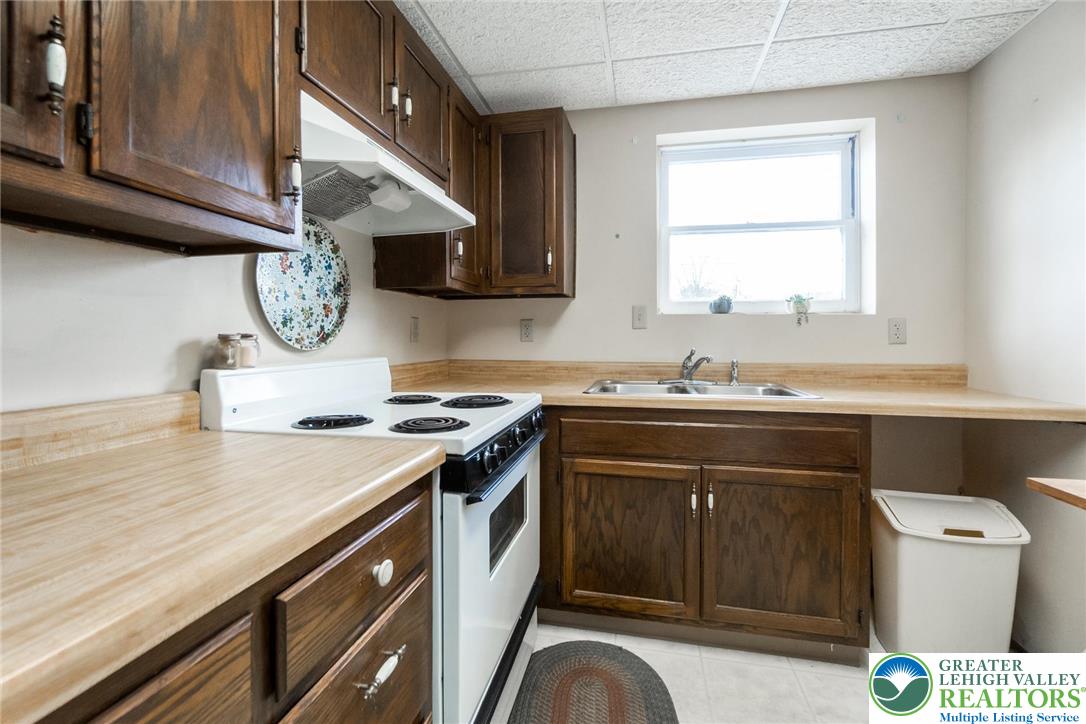 3218 Highland Road Orefield, PA 18069 - Photo 34 of 53 a kitchen with a stove cabinets and a window