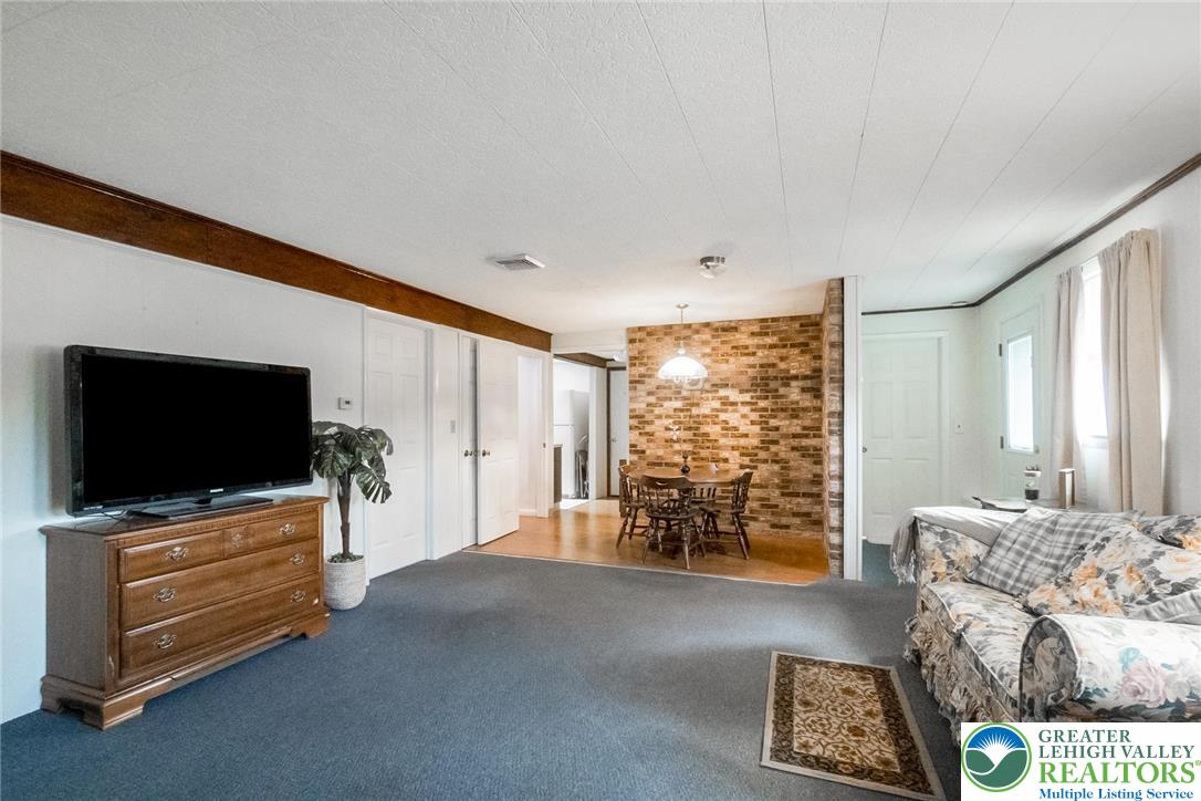 3218 Highland Road Orefield, PA 18069 - Photo 39 of 53 a living room with furniture and a flat screen tv