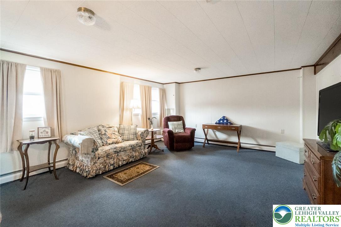 3218 Highland Road Orefield, PA 18069 - Photo 40 of 53 a living room with furniture and a flat screen tv