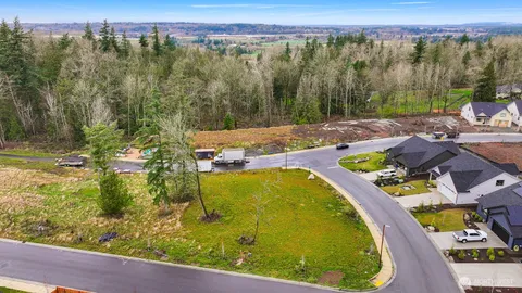 a view of a swimming pool with a patio and a yard