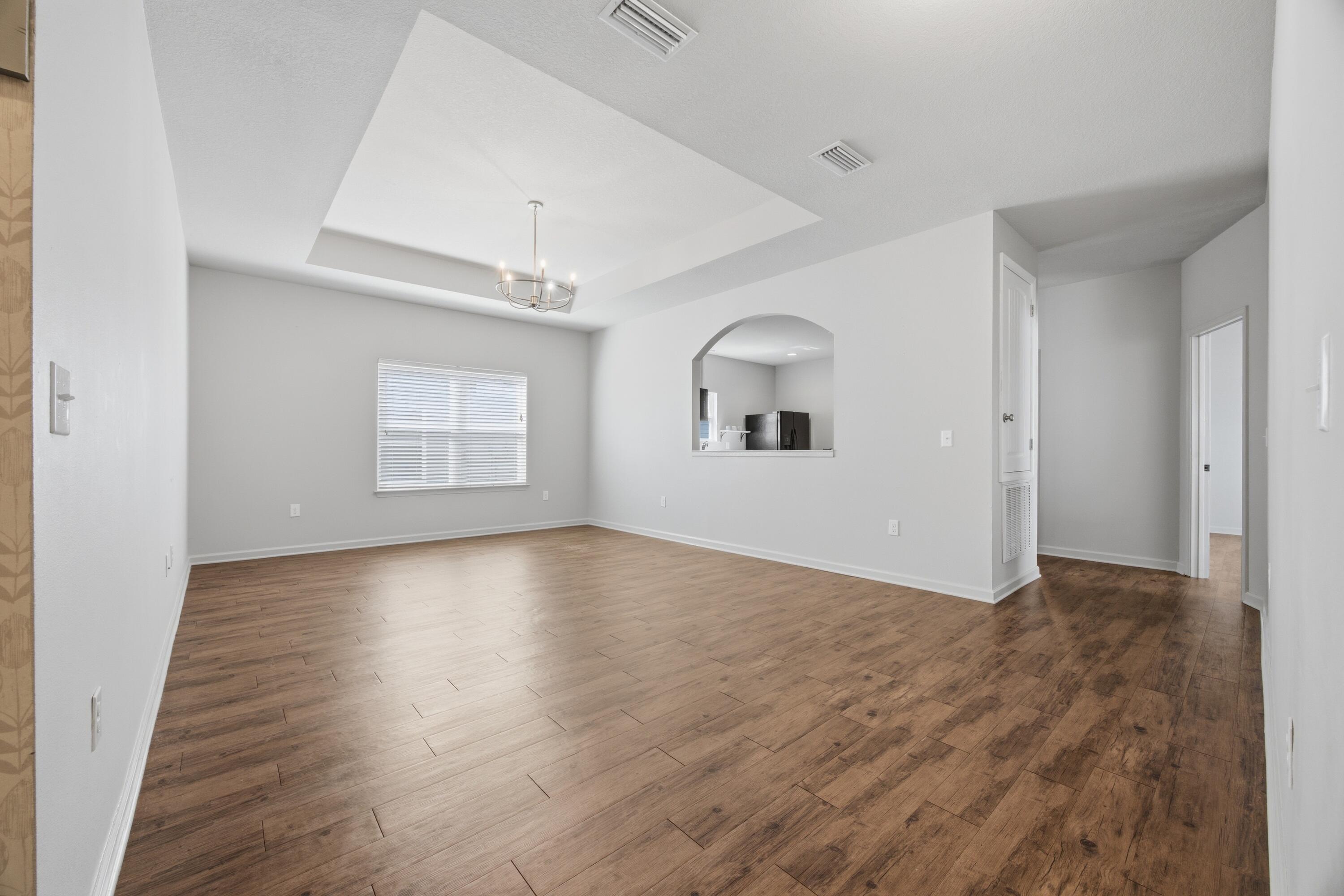 102 Cornelia Street Freeport, FL 32439 - Photo 16 of 39 an empty room with wooden floor and windows