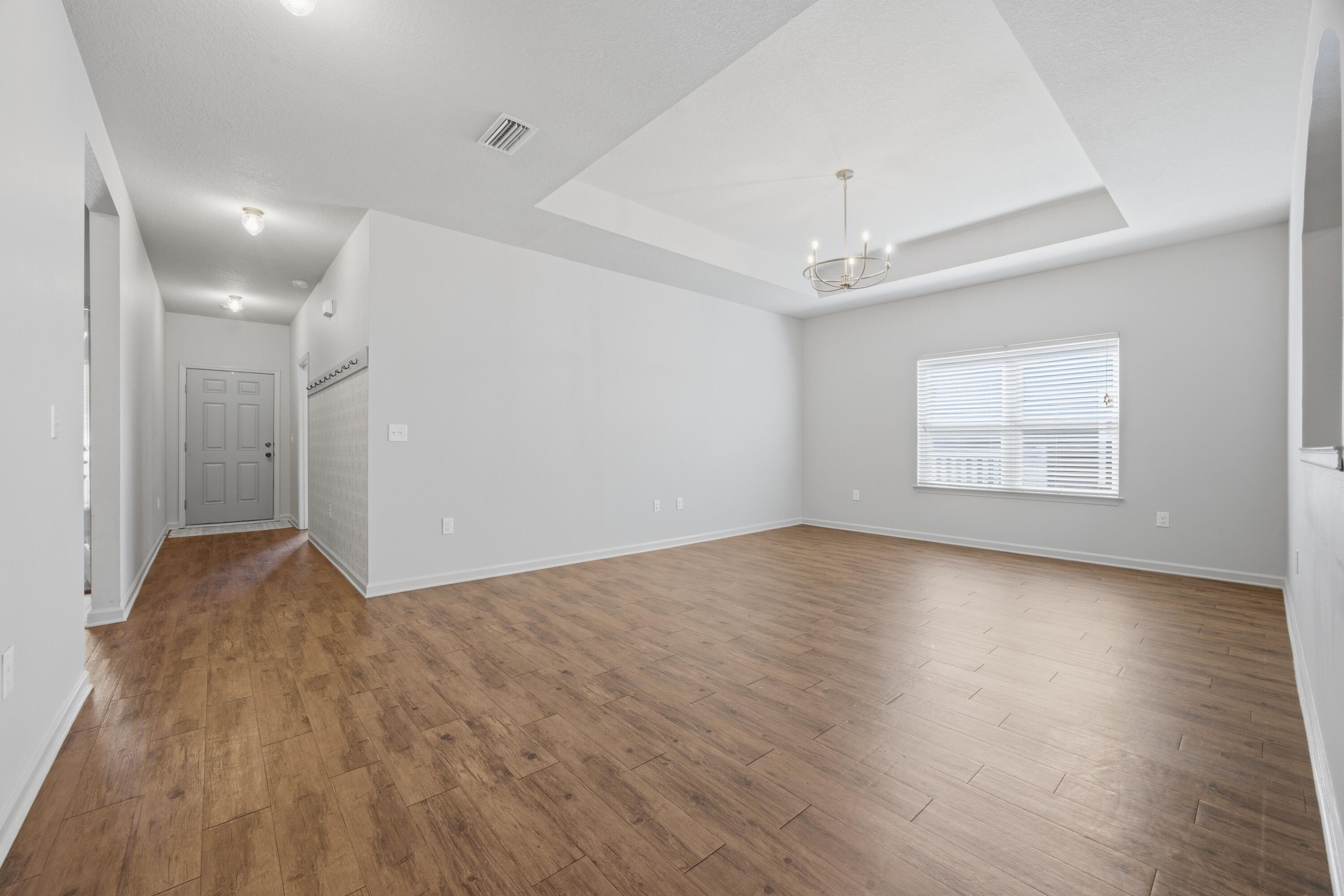 102 Cornelia Street Freeport, FL 32439 - Photo 17 of 39 an empty room with wooden floor and windows