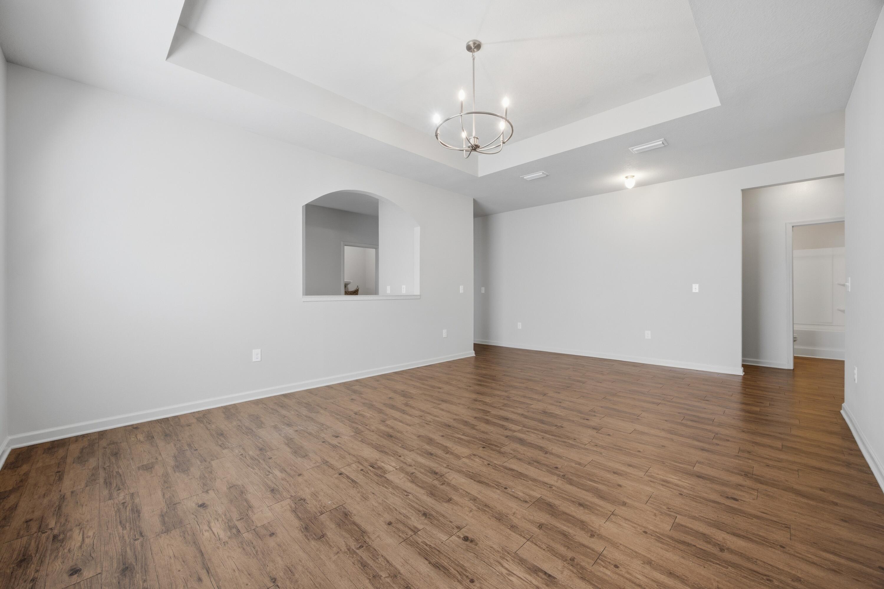 102 Cornelia Street Freeport, FL 32439 - Photo 18 of 39 a view of an empty room with wooden floor and a window