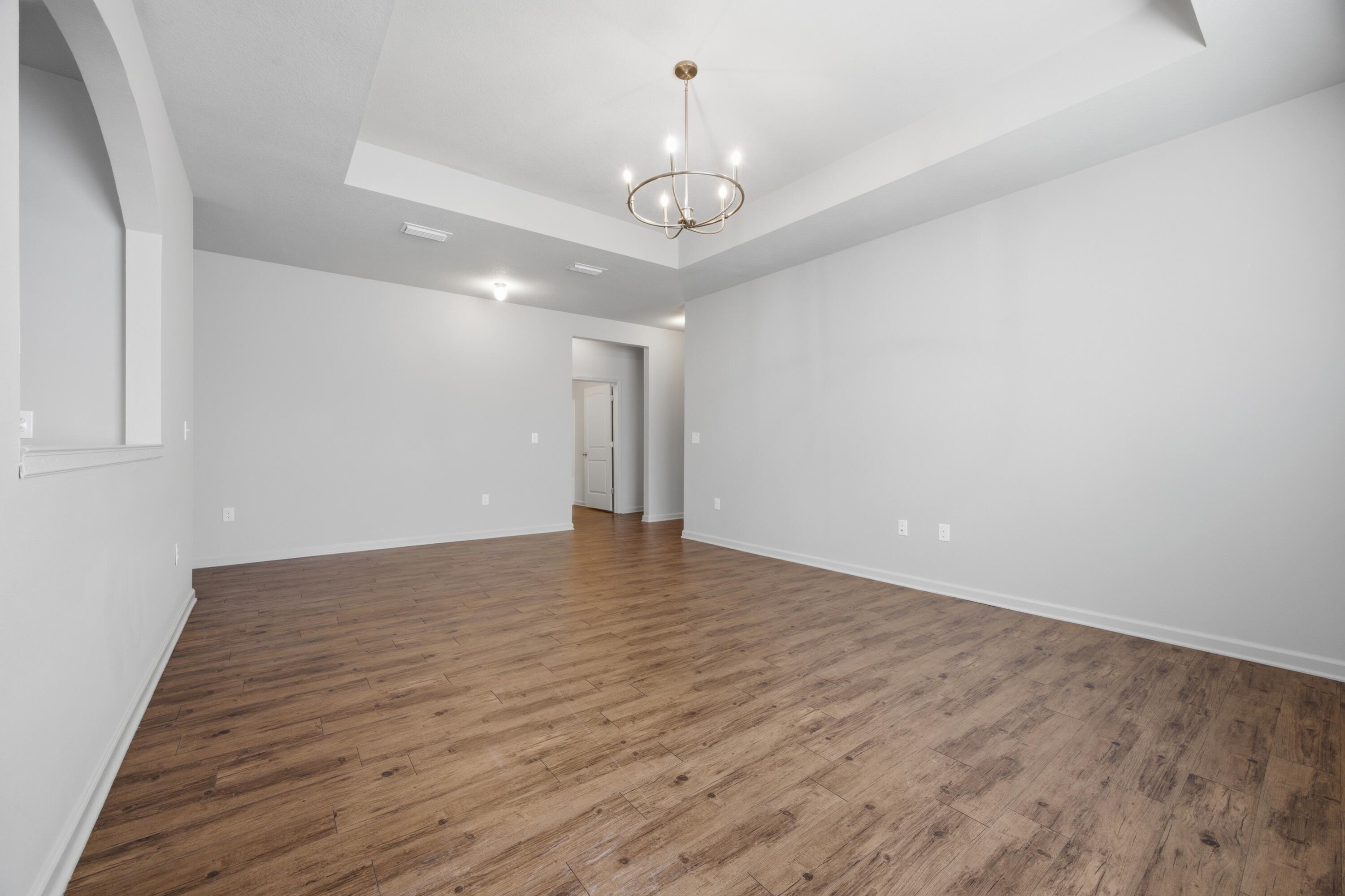 102 Cornelia Street Freeport, FL 32439 - Photo 19 of 39 a view of an empty room with wooden floor ceiling fan