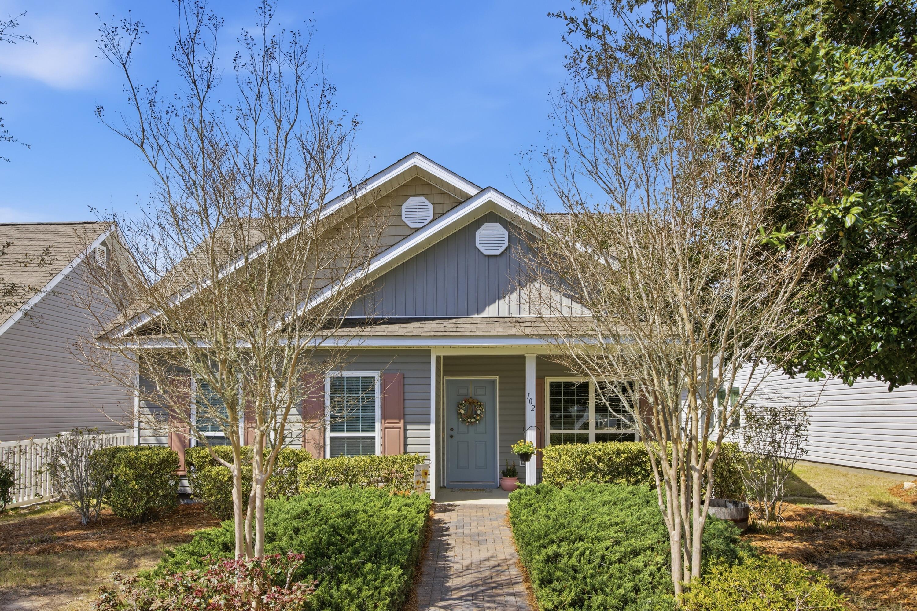 102 Cornelia Street Freeport, FL 32439 - Photo 2 of 39 a front view of a house with garden