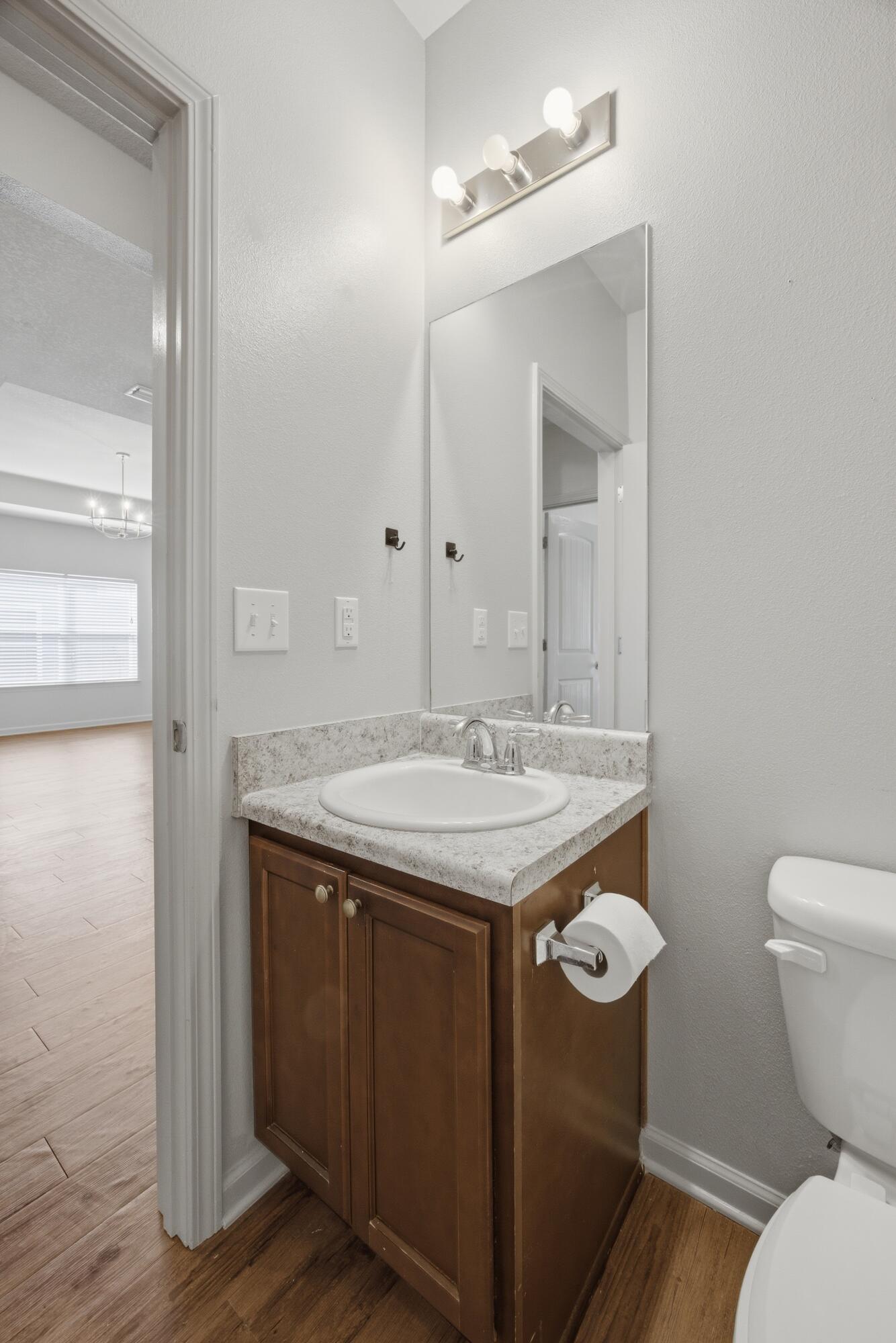 102 Cornelia Street Freeport, FL 32439 - Photo 21 of 39 a bathroom with a granite countertop sink a toilet and a mirror
