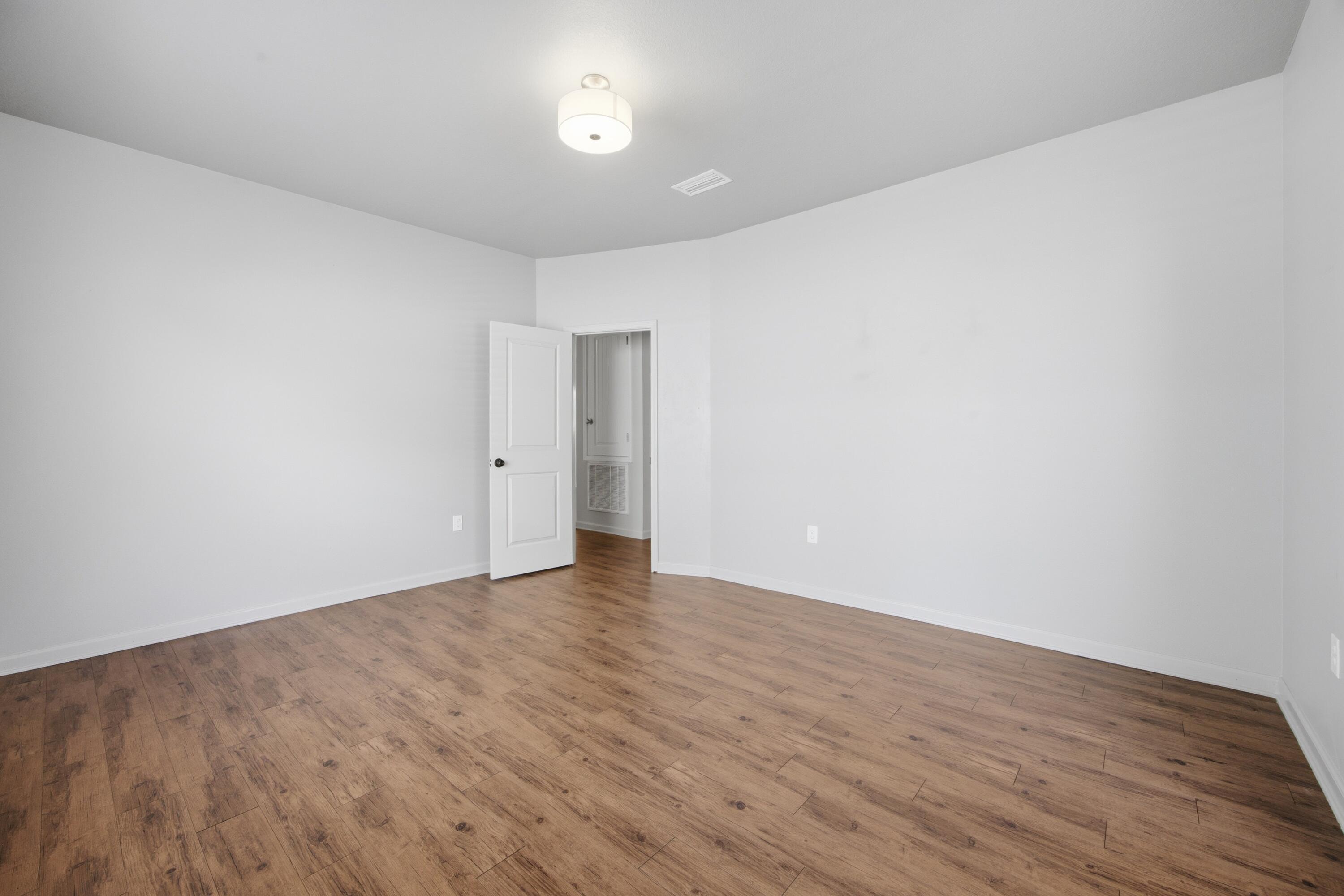 102 Cornelia Street Freeport, FL 32439 - Photo 29 of 39 a view of an empty room with wooden floor
