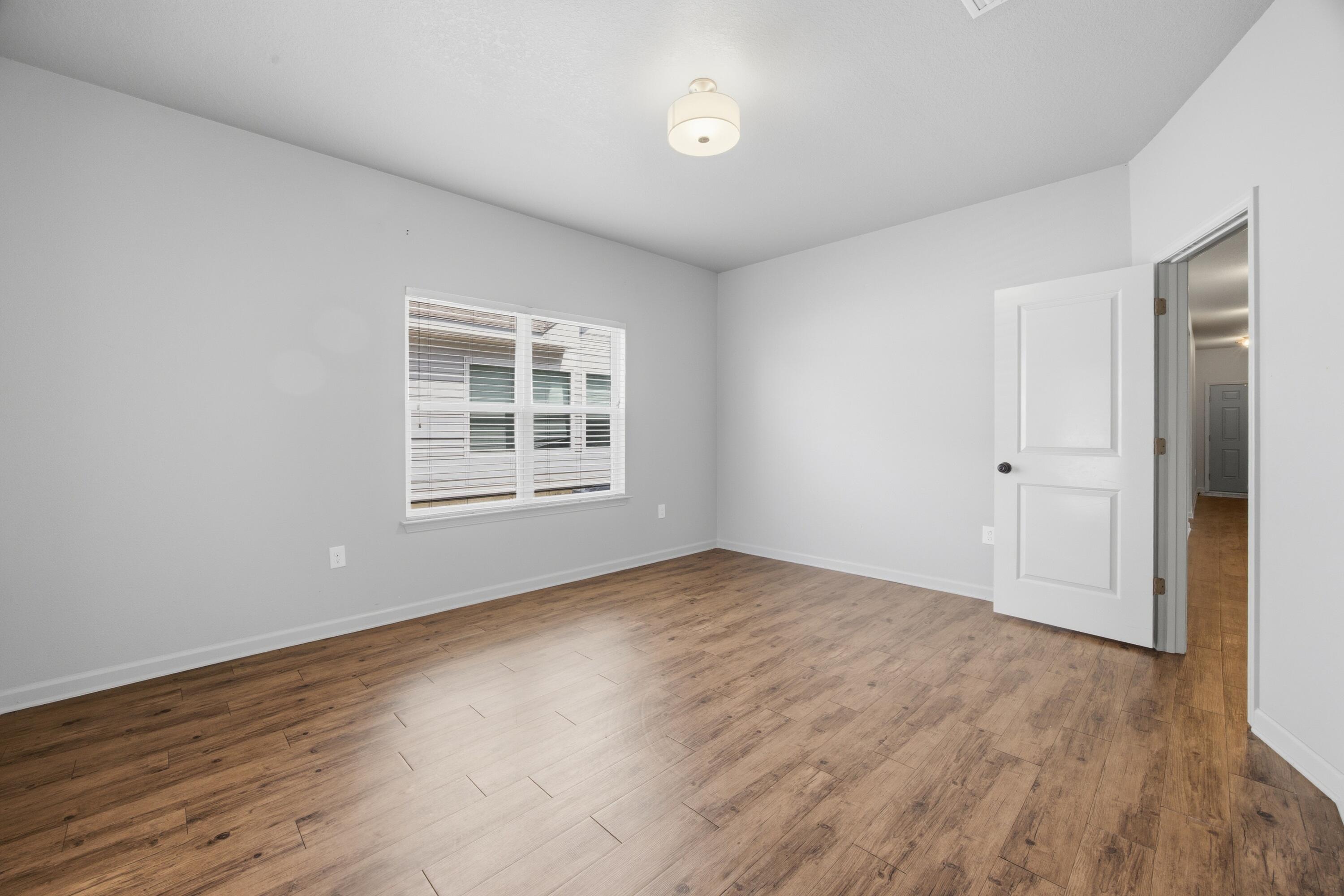 102 Cornelia Street Freeport, FL 32439 - Photo 30 of 39 a view of an empty room with wooden floor and a window